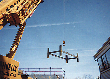 crane placing the newly fabricated base for a concrete bag house